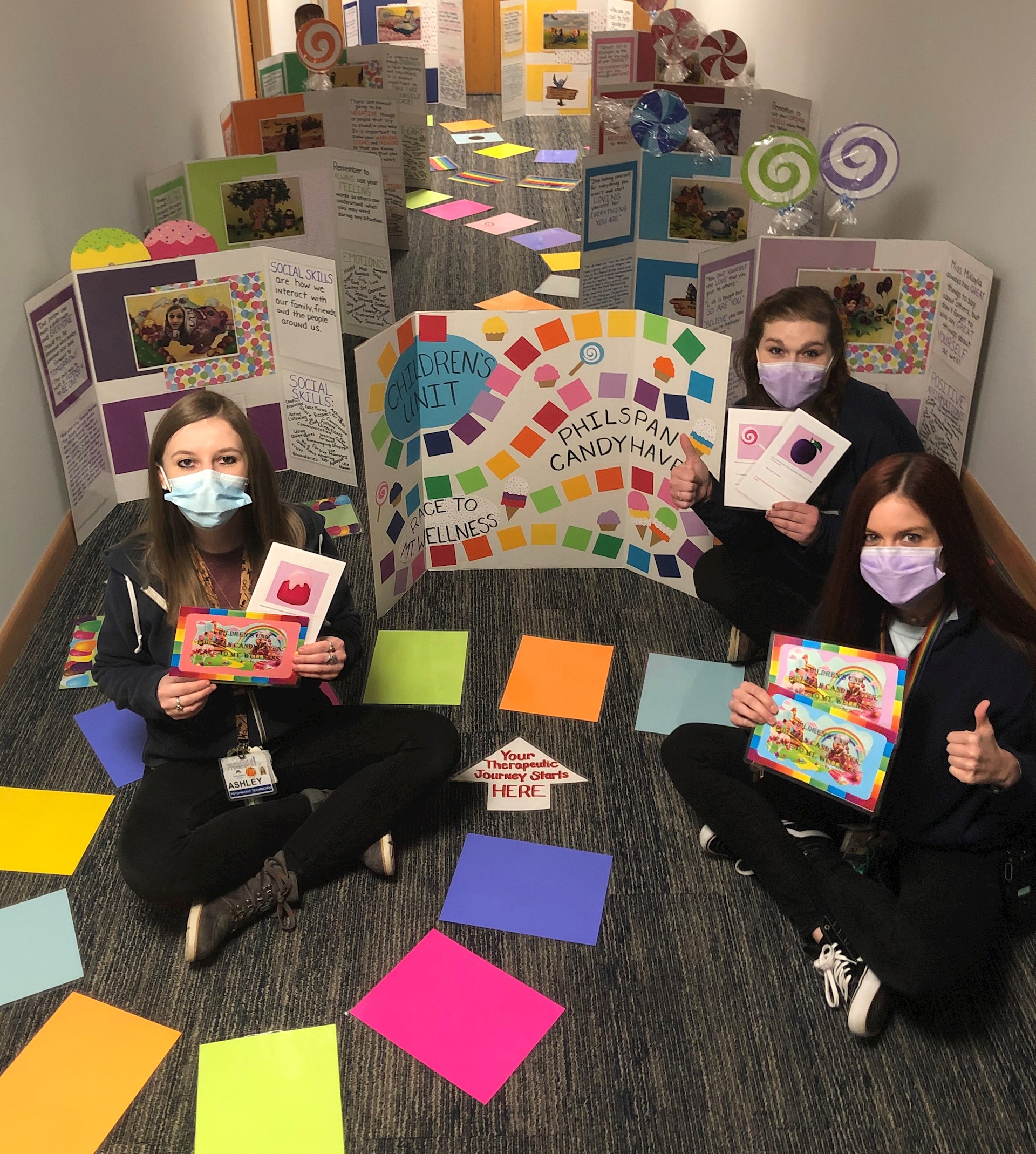 Ashley Nole, Megan Breckinridge and Allison Engle (from left) show the Candy Land game that Nole designed for children in the WellSpan Philhaven behavioral health unit at Mt. Gretna.