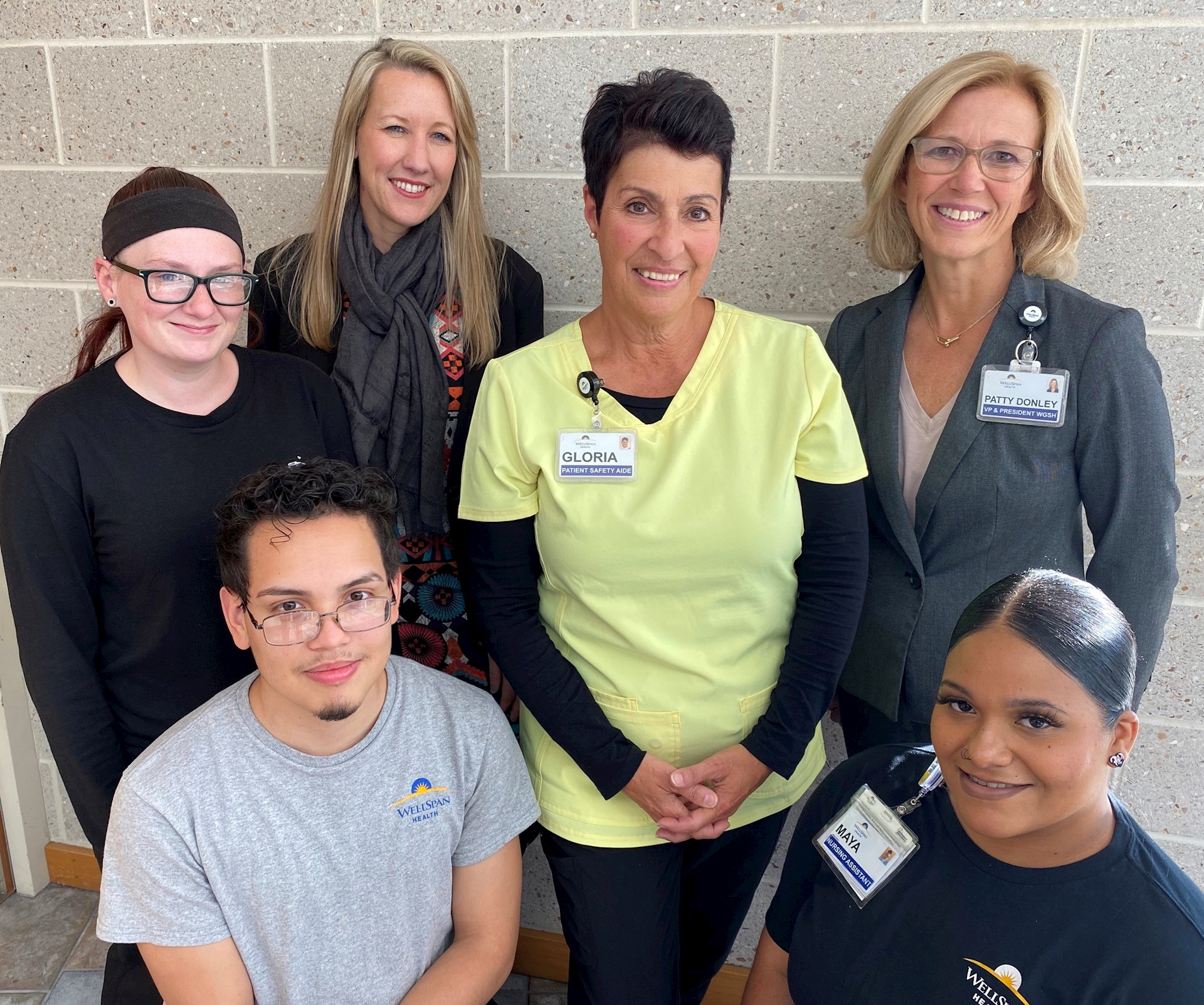 Gloria Tice (center) surrounded by her former students who work at WellSpan (clockwise, from lower left) Cristhian Torrez, Samantha Boyer, Dr. Rhian Davies, Patty Donley, and Mayalani Bracero.
