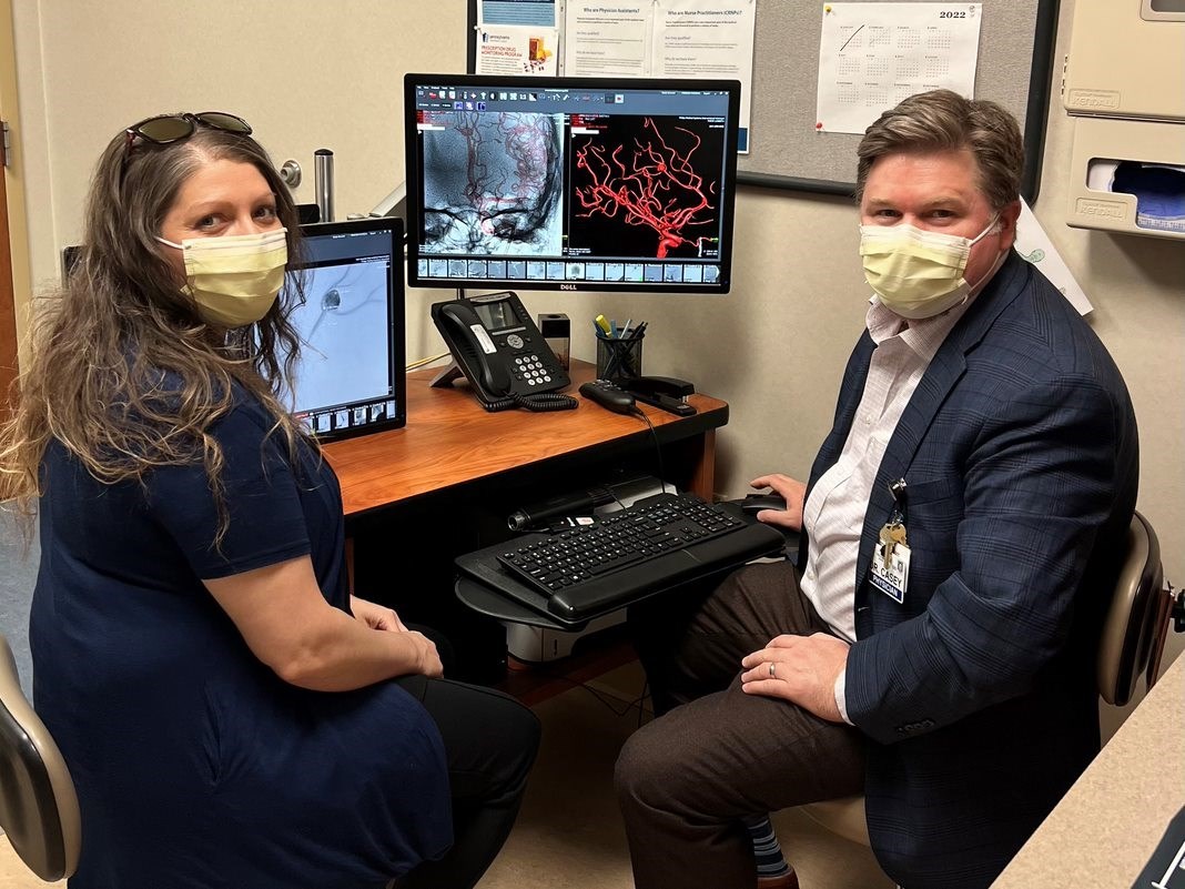 Tabitha Finucan Pacheco looks at an image of her brain aneurysm with WellSpan neurosurgeon Dr. Michael Casey, who repaired the bulging blood vessel.