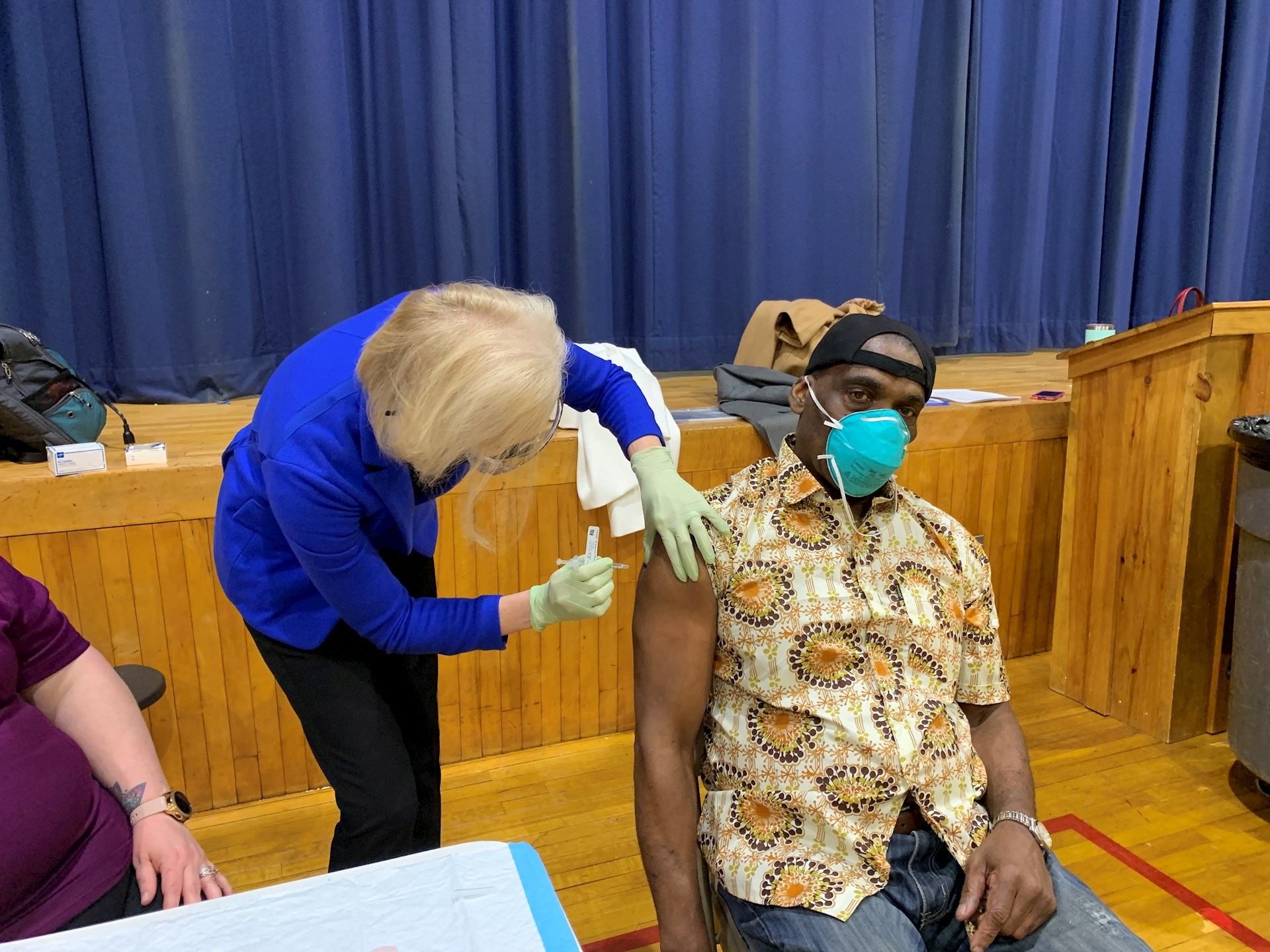 Roxanna Gapstur, PhD, RN, President and CEO, administers COVID-19 vaccines as part of the mobile vaccination effort. Robert Simpson, CEO, Crispus Attucks Crispus Attucks receives his vaccine along with other qualified community members in phase 1a.