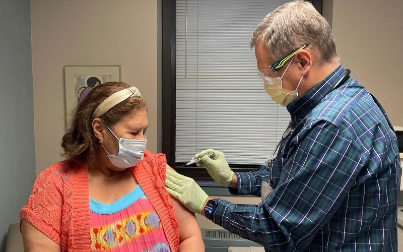 WellSpan family physician Dr. Mark Goedecker,  vice president and chief medical officer for primary care, administers a flu shot to Nelly Garcia at the Thomas Hart Family Practice Center.