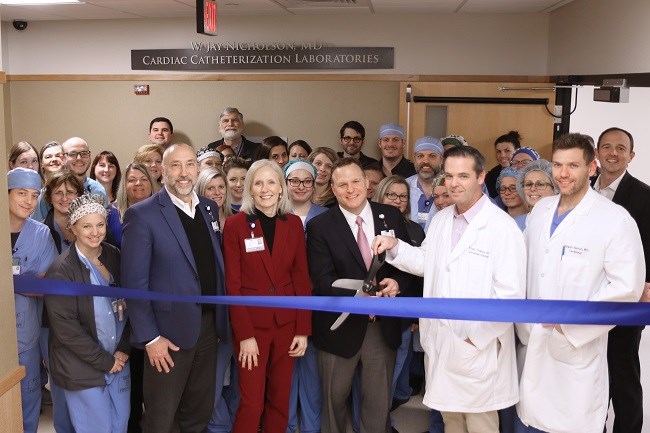The cardiac catheterization lab team at WellSpan York Hospital is joined by WellSpan Health leadership to cut the ribbon to the expanded space.