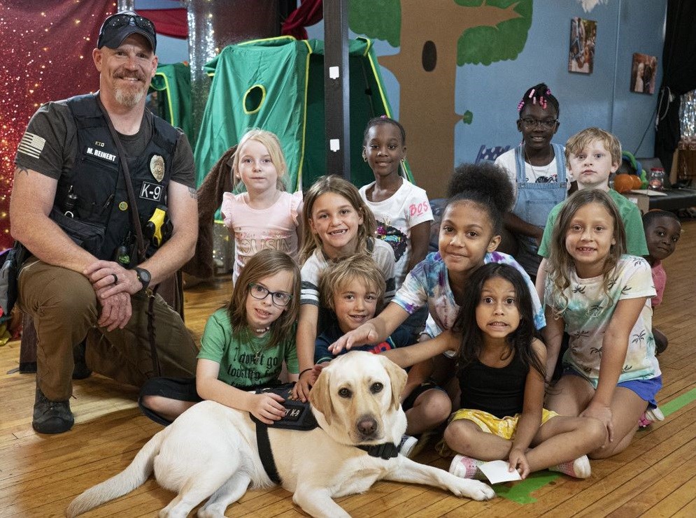 More than 50 York-area children received scholarships to attend camp this summer through WellSpan’s Inspire Grant. Pictured above are youth in camp at the Curious Little Playhouse. Each week, campers  spent time with therapy dogs from the York City Police Department.