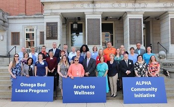 Many of the community partners in the three programs recognized by the Hospital and Heathsystem Association of Pennsylvania’s 2019 “Living the Vision” Award this year gather on the steps of the York County Administrative Center. Nonprofits, agencies and local government all played a vital role in efforts to address the critical issues of housing insecurity and continuing care access.
