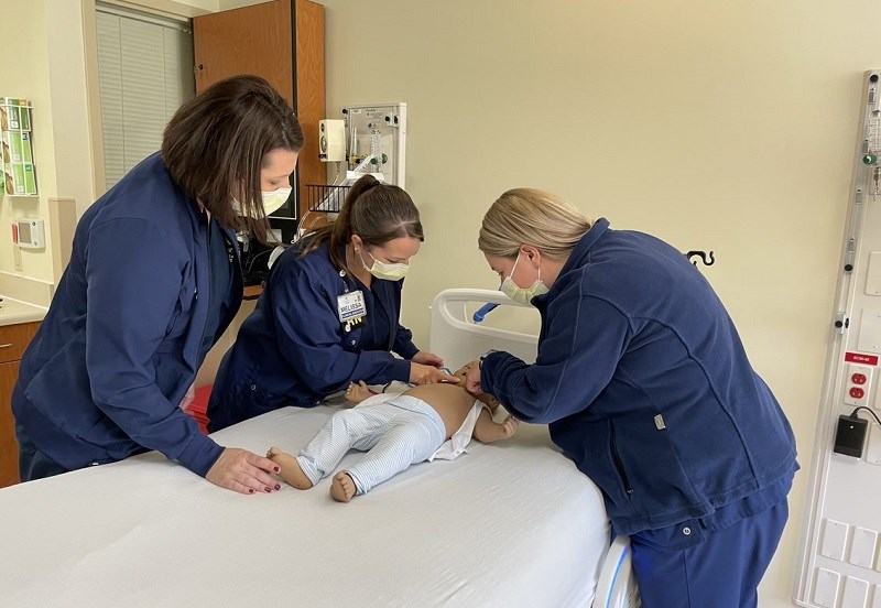 Nurses at WellSpan Chambersburg Hospital run mock codes on a new simulated baby as they learn how to respond to critically ill pediatric patients.