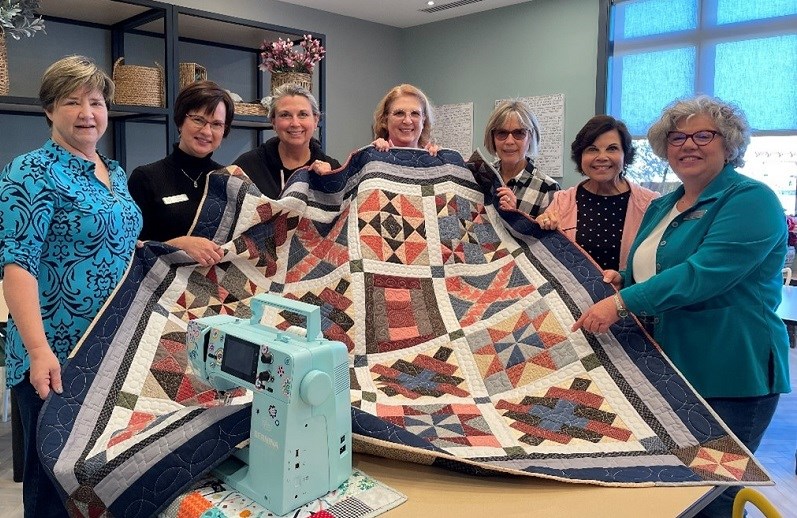 The Amblebrook quilting group displays their first ever quilt project to be shared with patients and caregivers at the WellSpan Adams Cancer Center.
