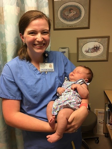 Katherine Johnson, CNM, holds a baby that she helped to deliver.