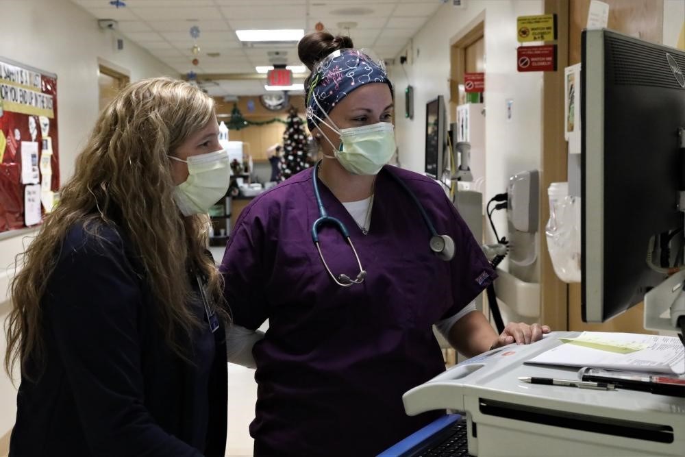 WellSpan Surgery and Rehabilitation Hospital Nurse Manager Kelly Shifflet (left) and Lt. Cassandra Dusseau, a clinical nurse on the Department of Defense Augmentation Team, review a patient’s medical chart.